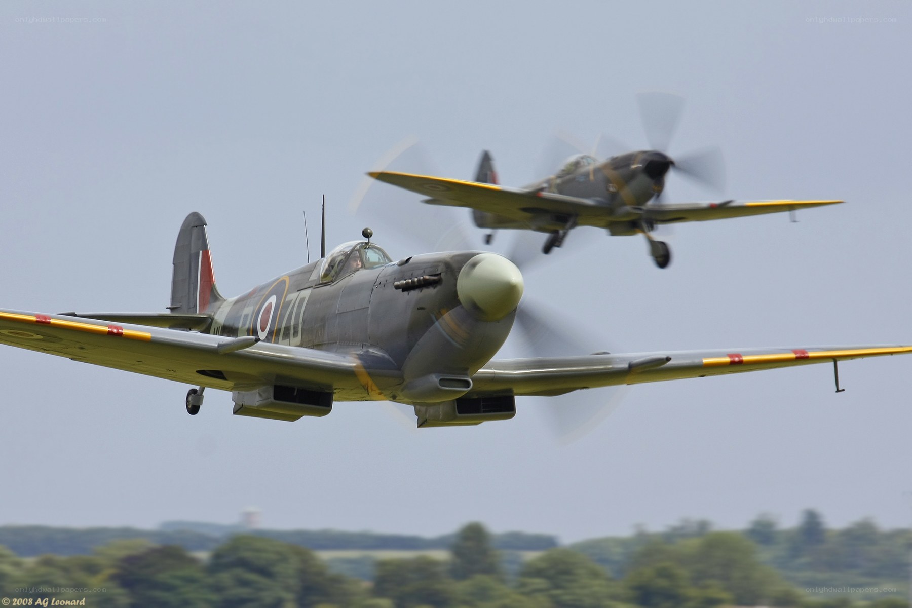 Two vintage fighter planes in flight