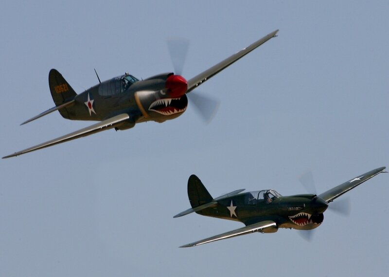 Two vintage military planes in flight