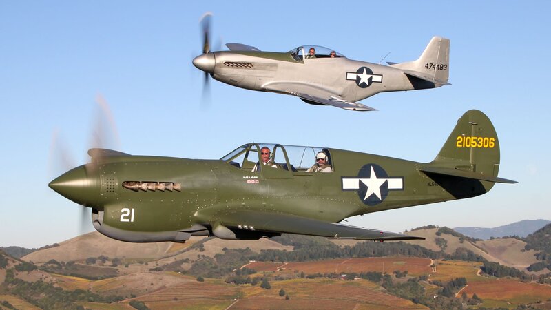 Two vintage military planes in flight