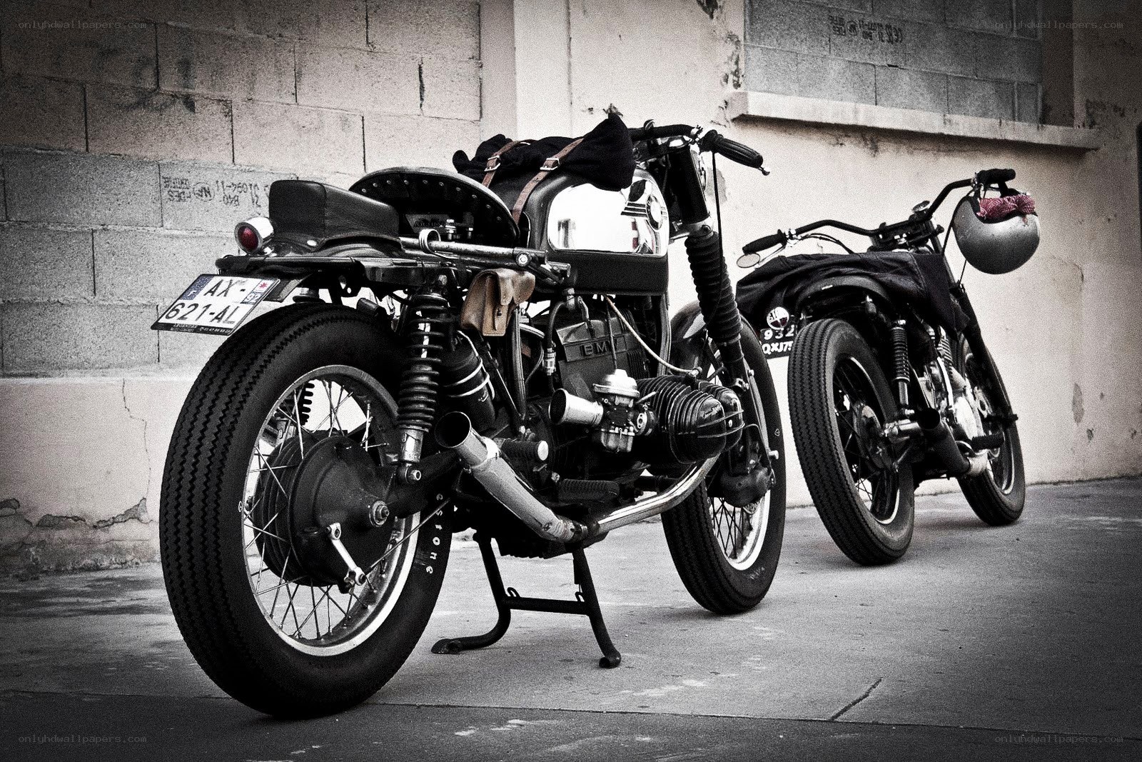 Two vintage motorcycles parked