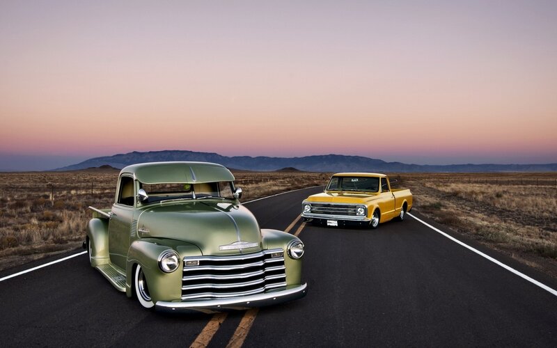 Two Vintage Trucks on Road