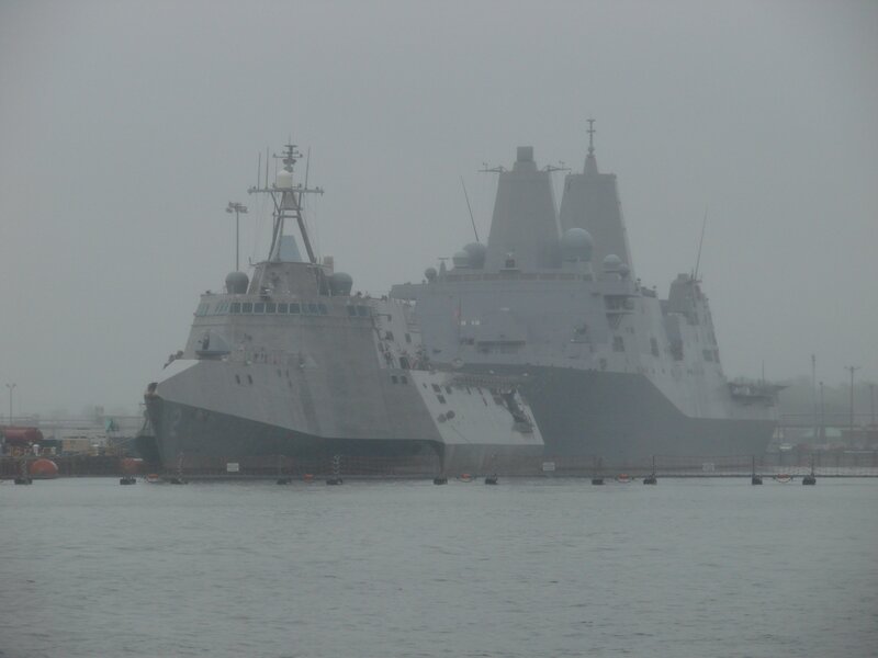 Two warships in a foggy harbor