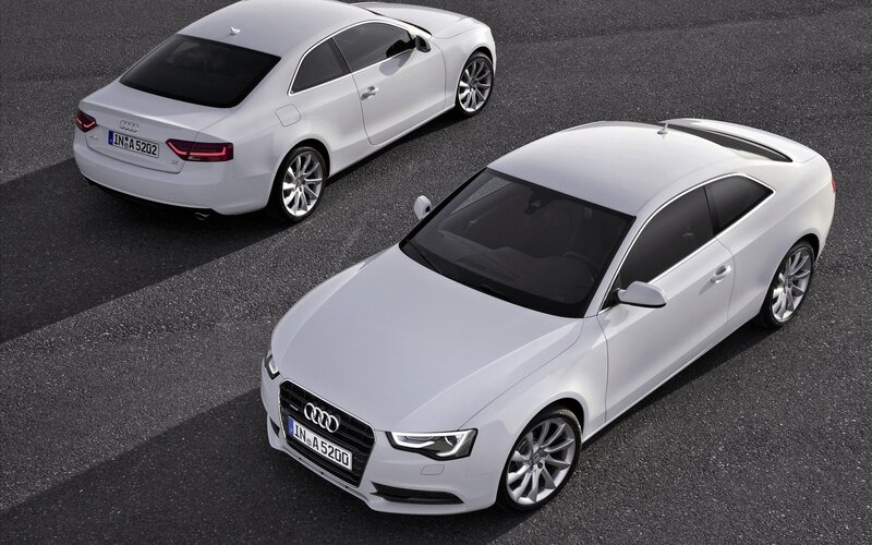 Two white Audi coupes