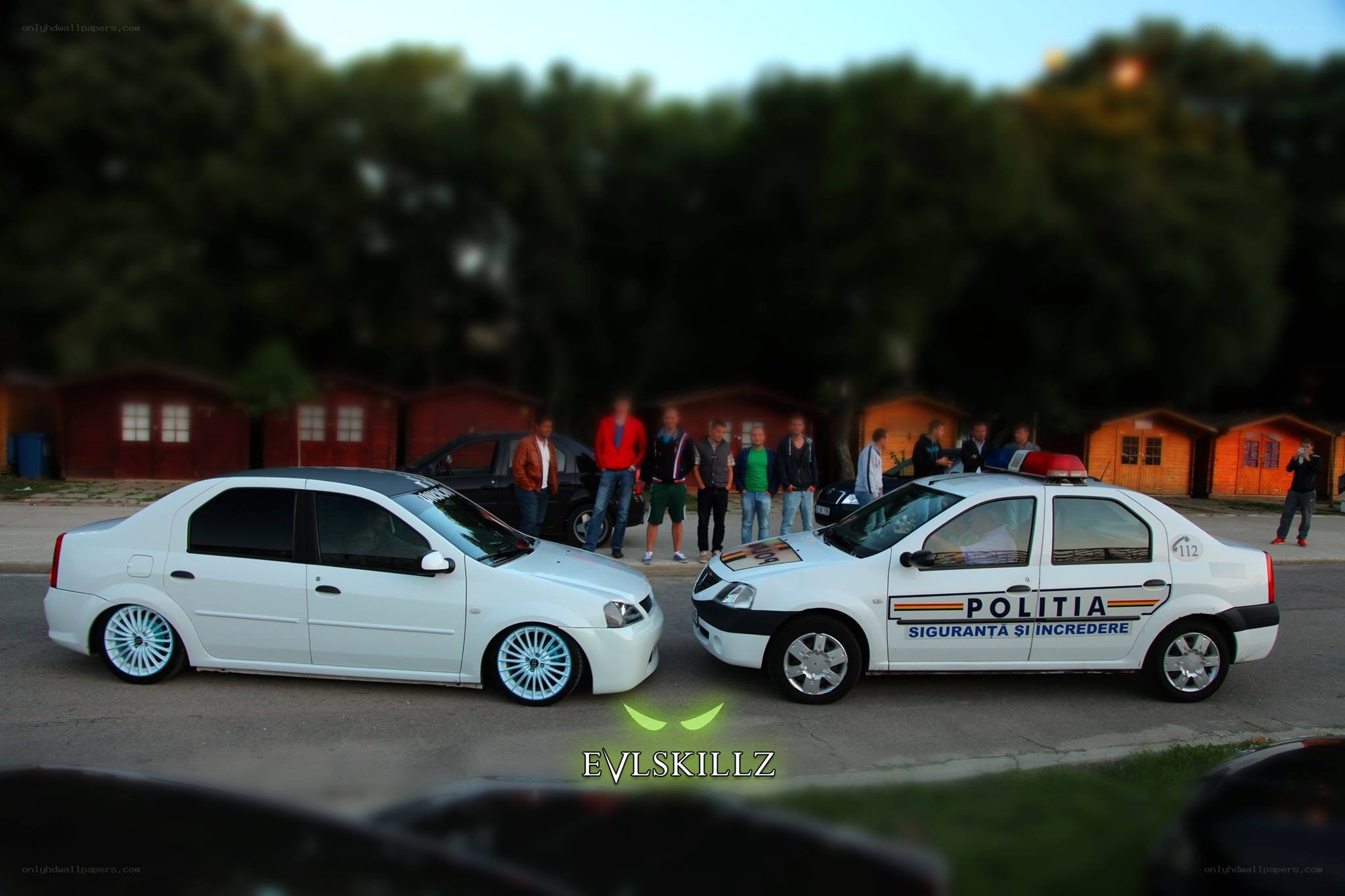 Two white cars at a gathering