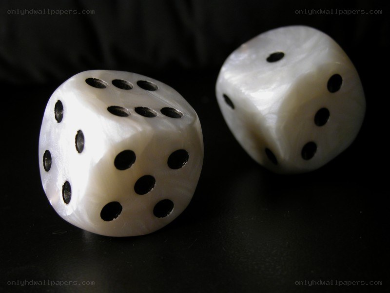 Two white dice on black surface