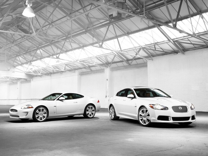 Two white Jaguars in a warehouse