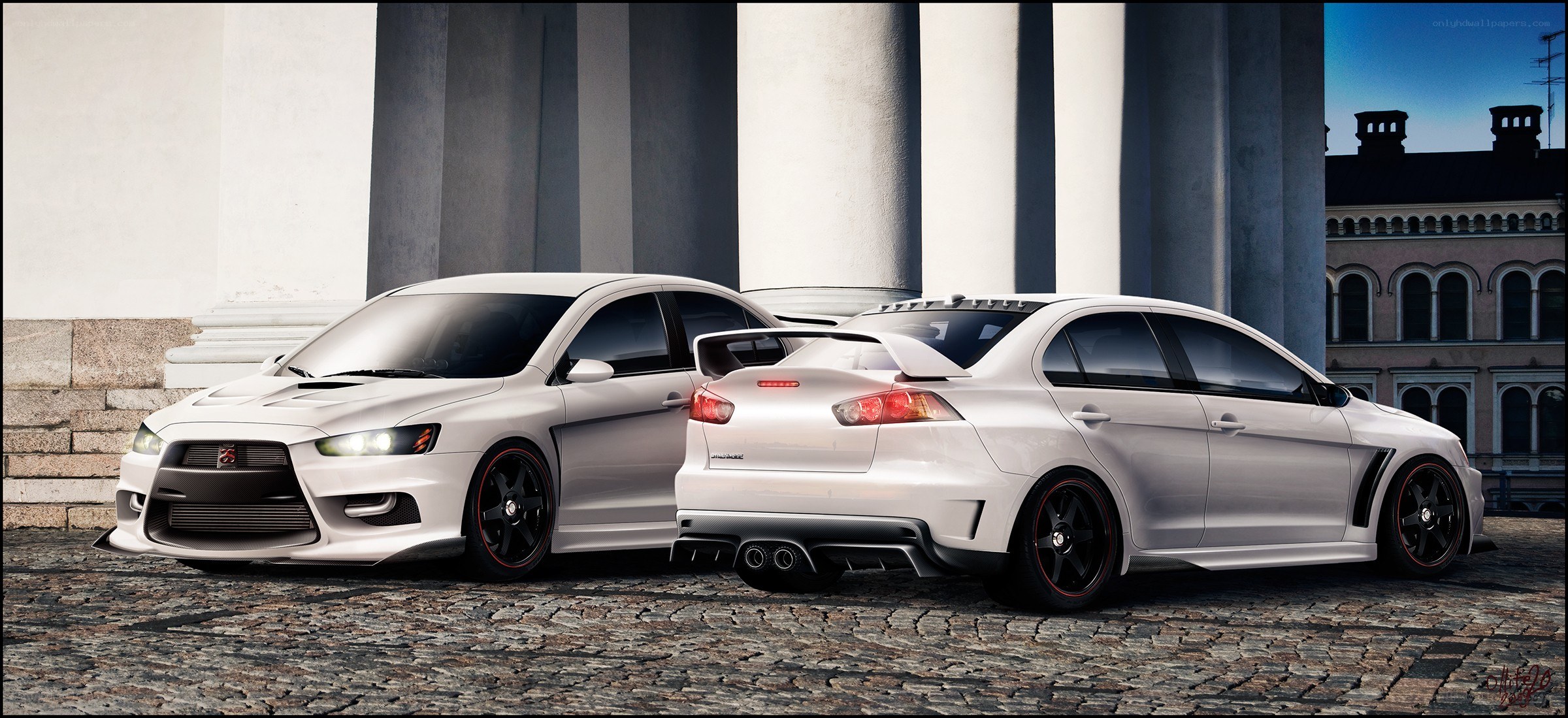 Two white Mitsubishi Lancers