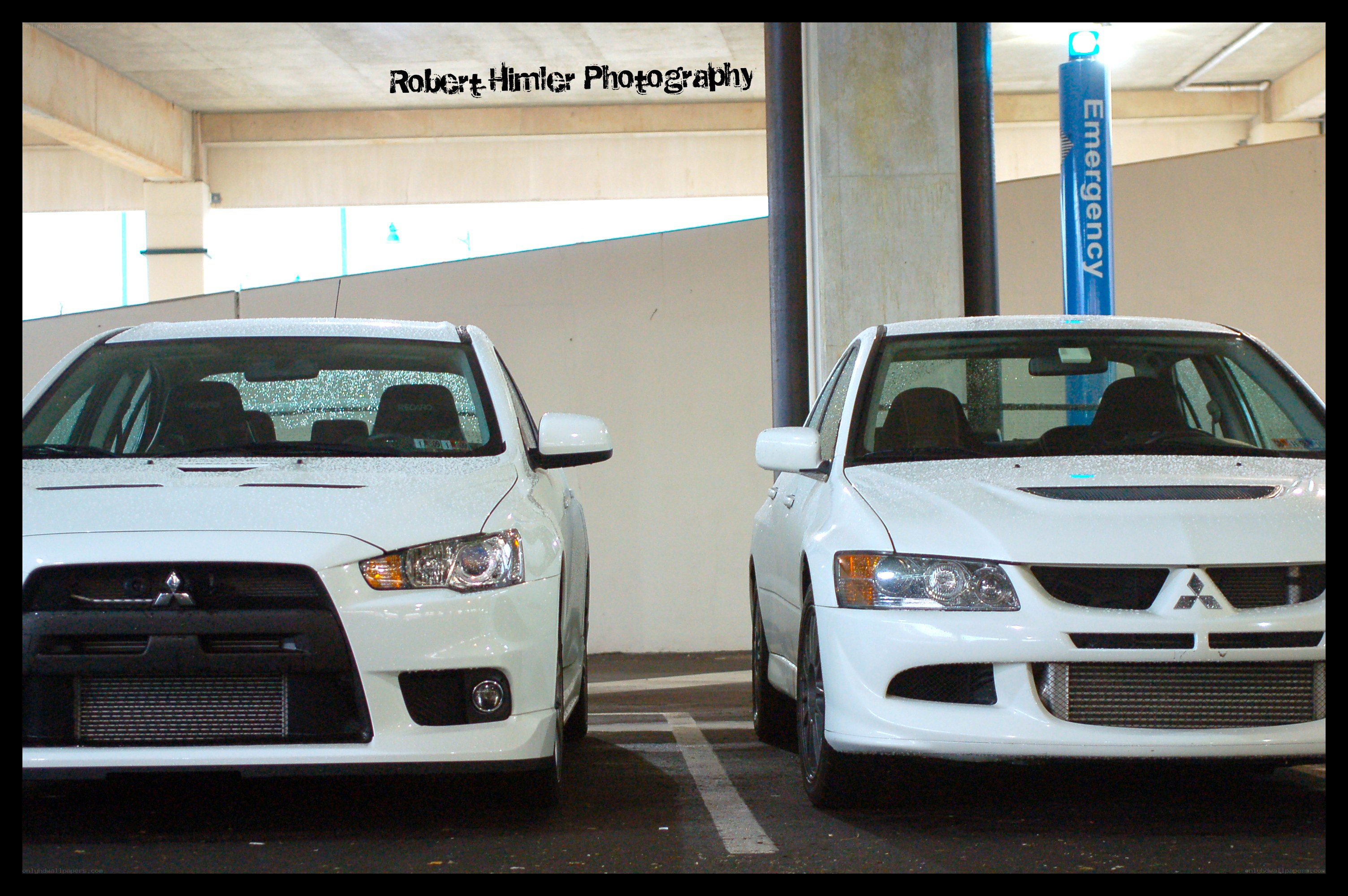 Two white Mitsubishi Lancers