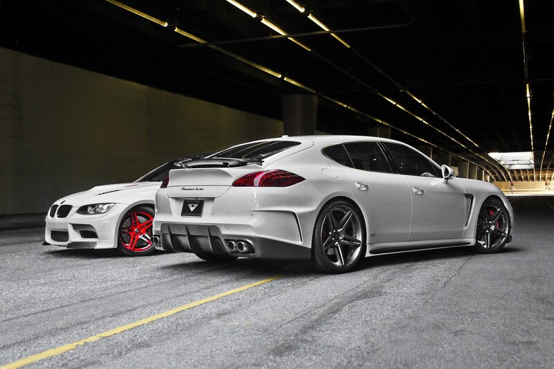Two white performance cars in garage