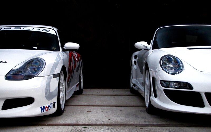 Two white Porsche race cars