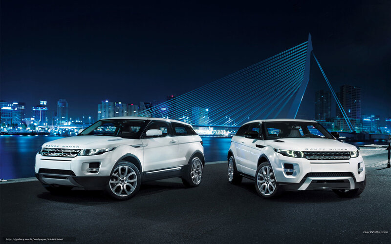 Two white Range Rovers at night