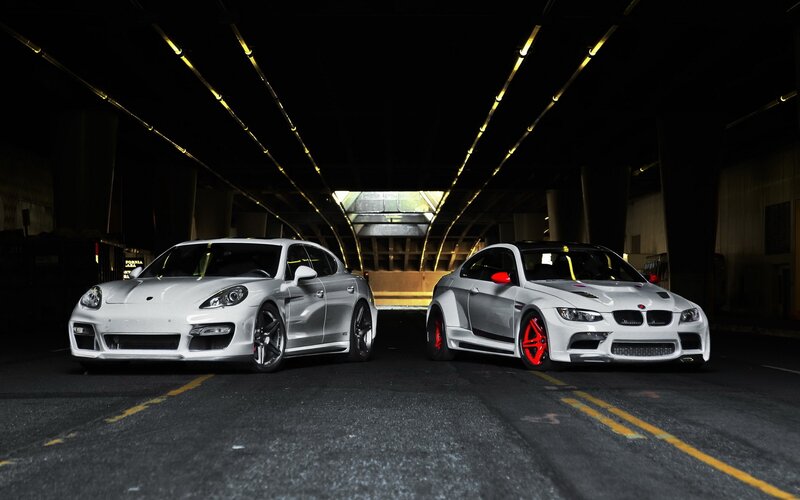 Two white sports cars in a tunnel