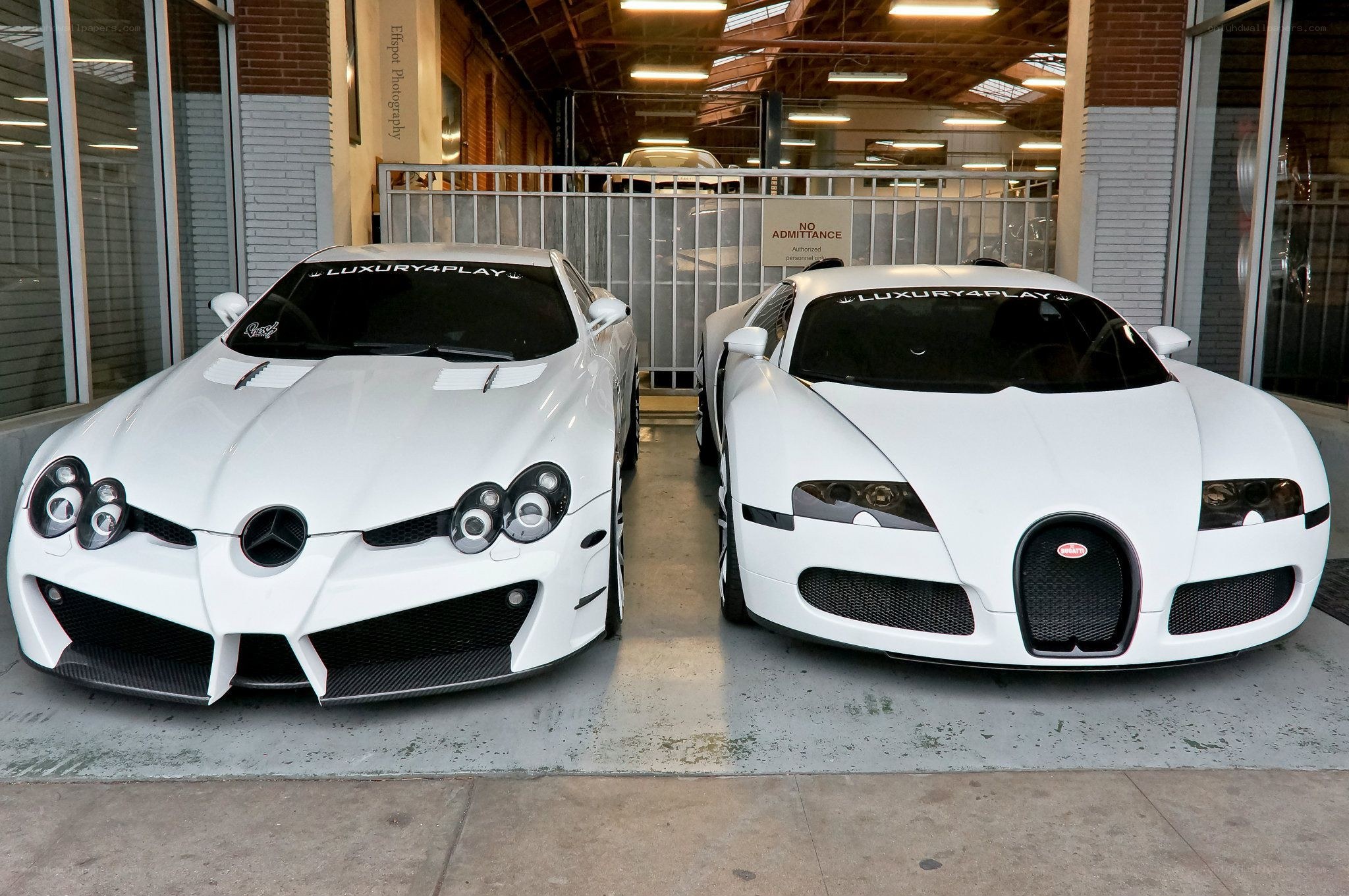 Two white supercars parked