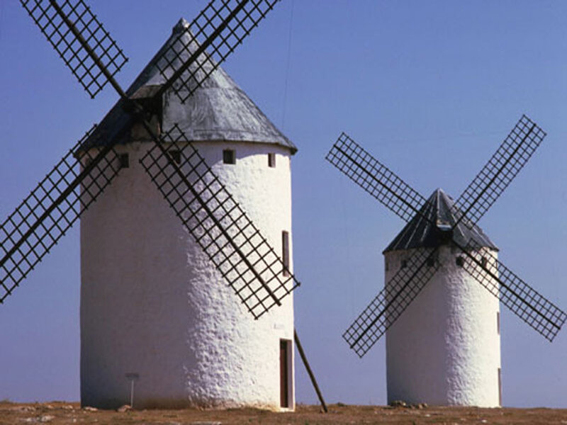 Two windmills in a field