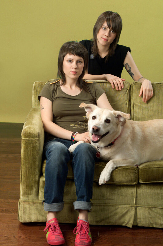 Two women and a dog on a couch