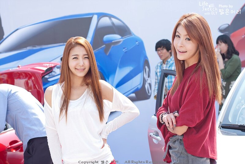 Two women at a car event