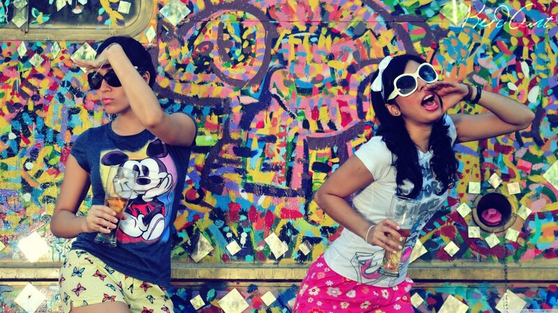 Two women at a colorful wall