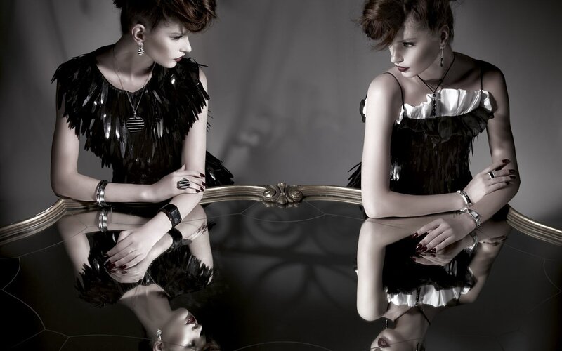 Two women at a reflective table