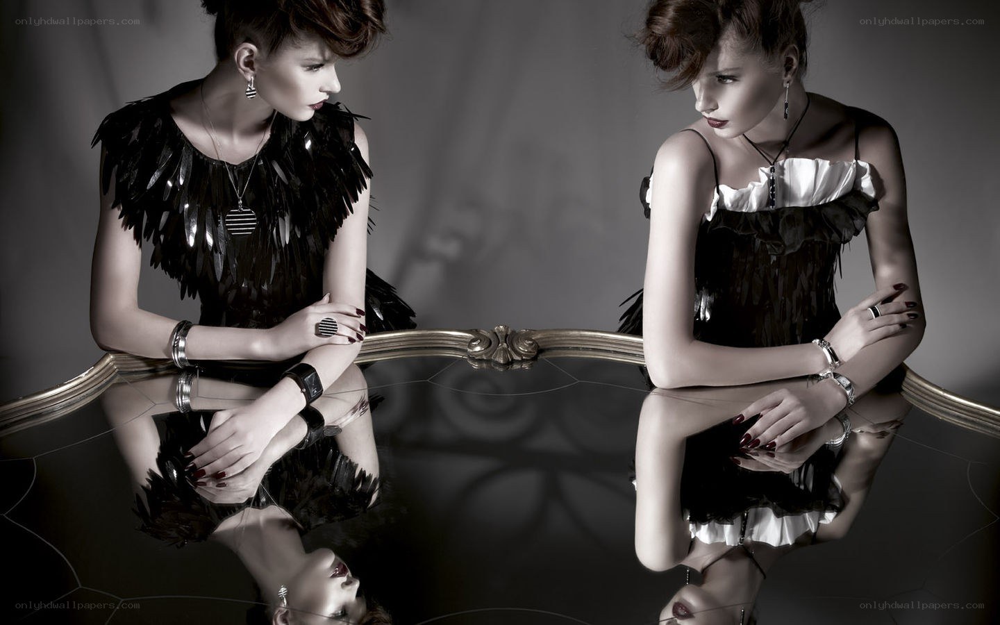 Two women at a reflective table