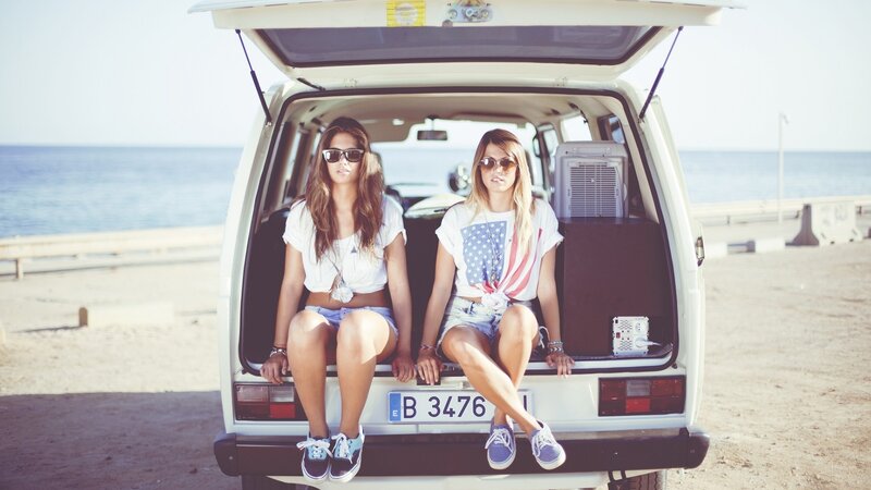 Two women at beach in van
