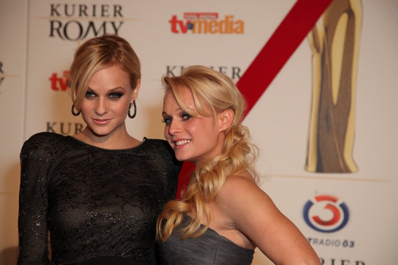 Two Women at Event — Black, Formal, Photograph, Backdrop, Award Statue