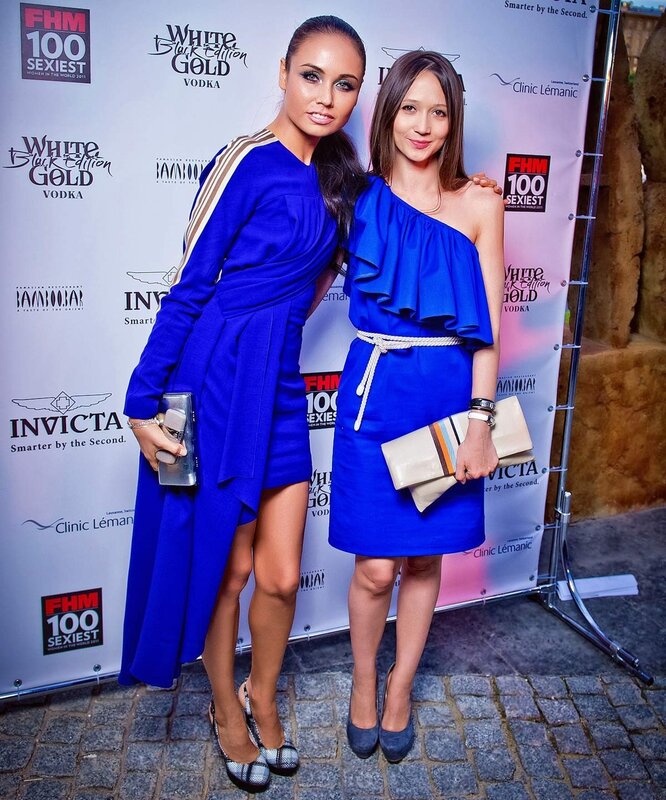 Two women at event in blue dresses