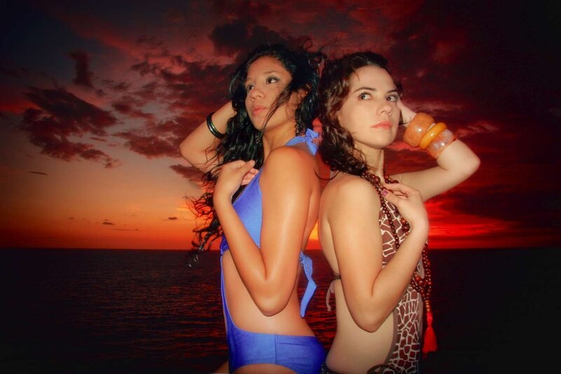 Two women at sunset by the sea