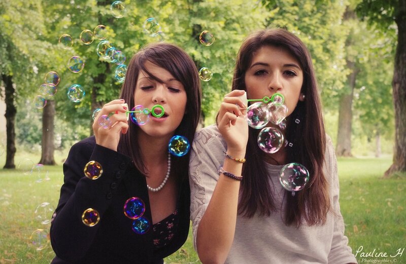 Two women blowing bubbles