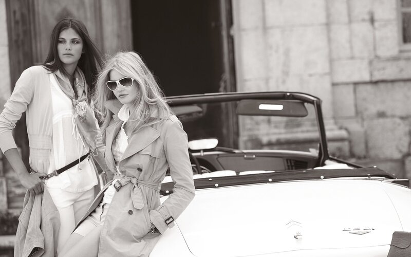 Two women by a classic car