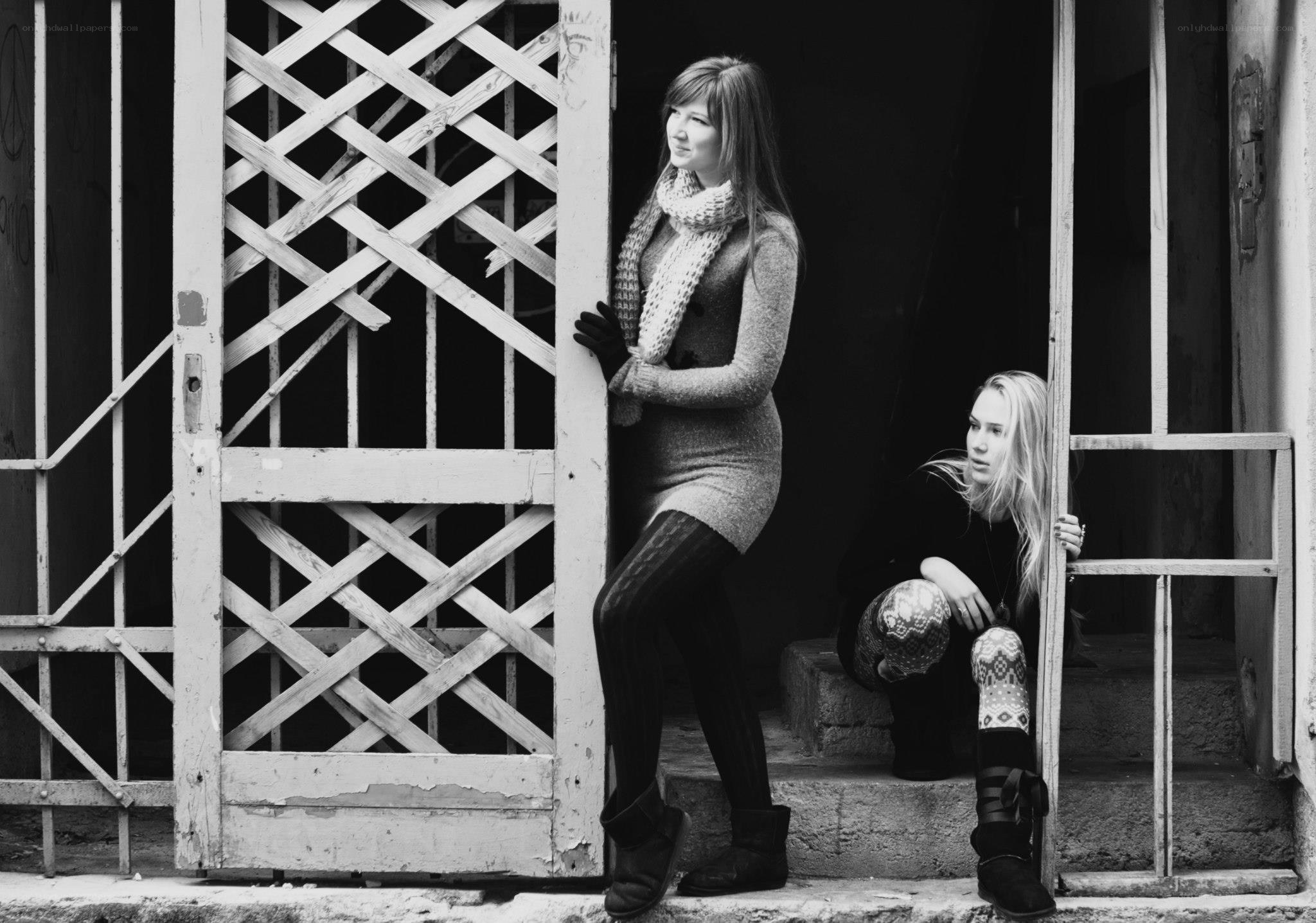 Two women by a gate