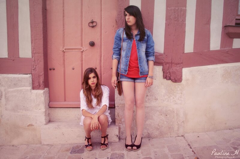 Two women by a pink door