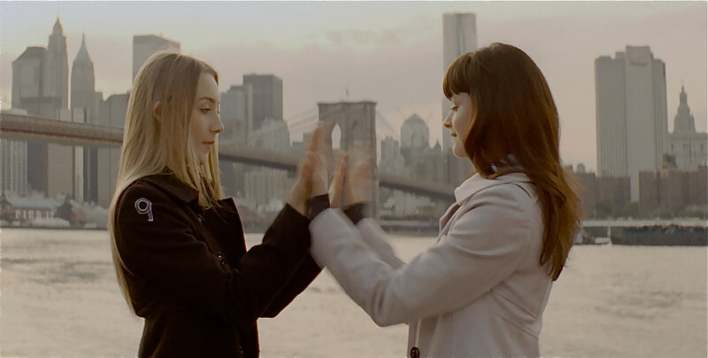 Two women clapping hands