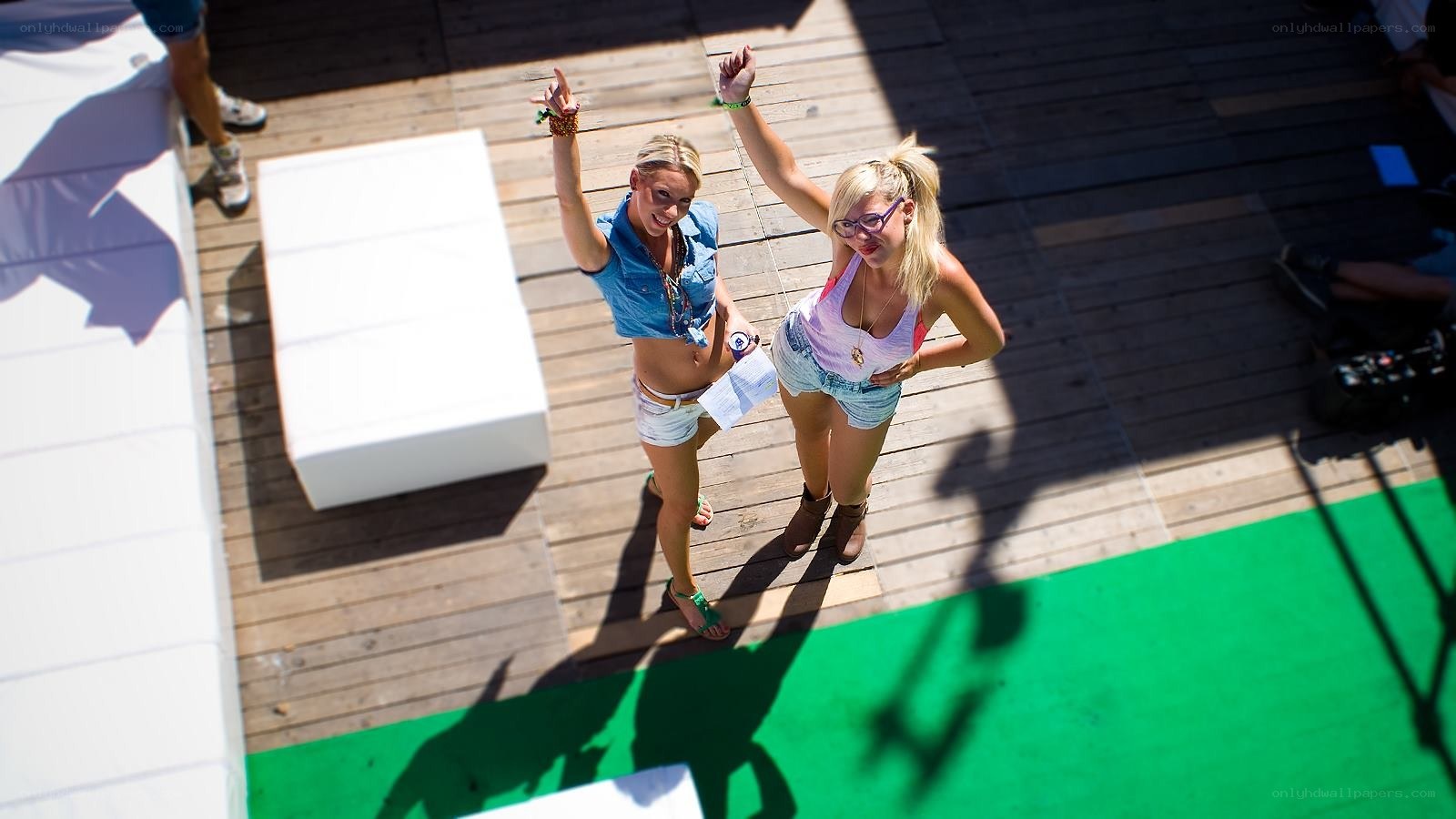 Two women dancing on a deck