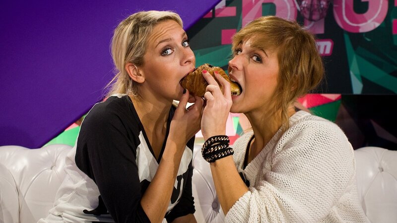 Two women eating a croissant