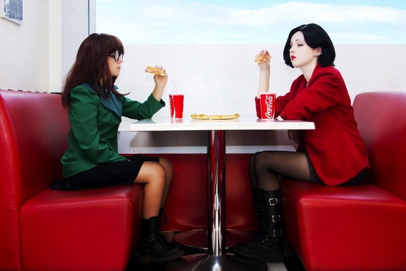 Two women eating pizza in a diner