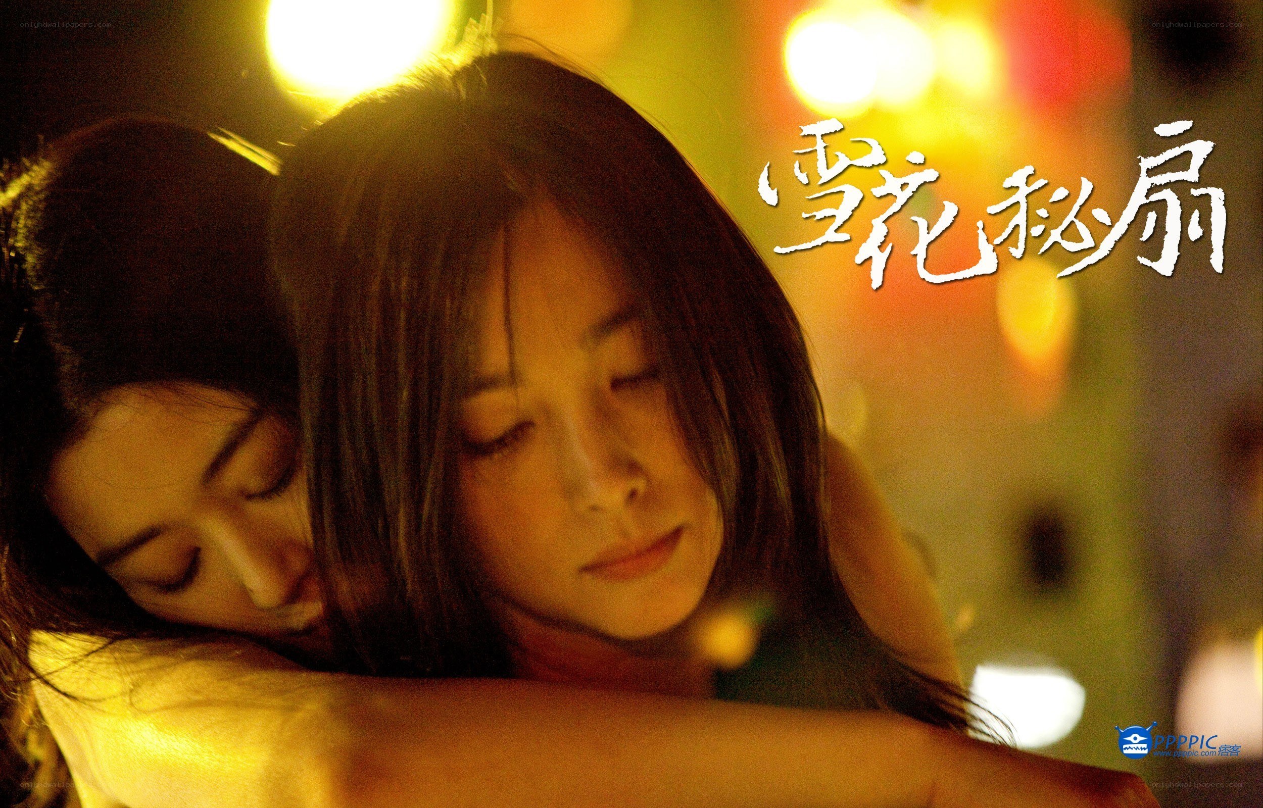 two women embracing at night
