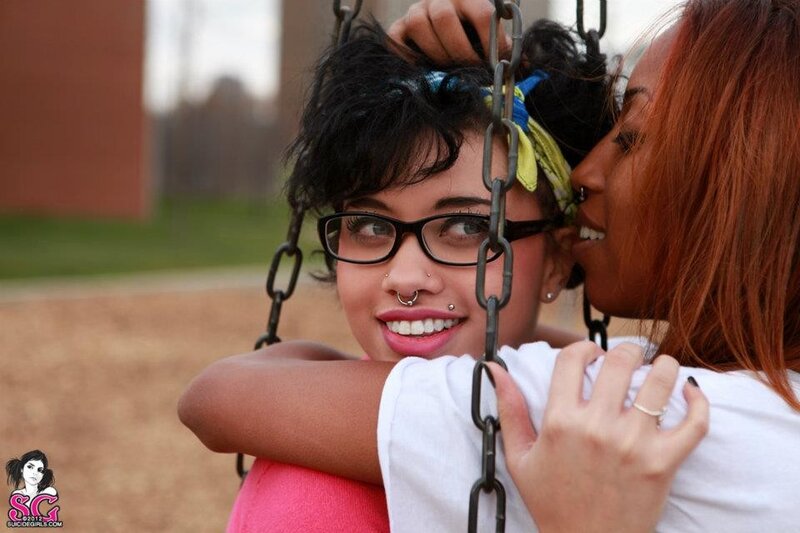 Two women embracing on a swing
