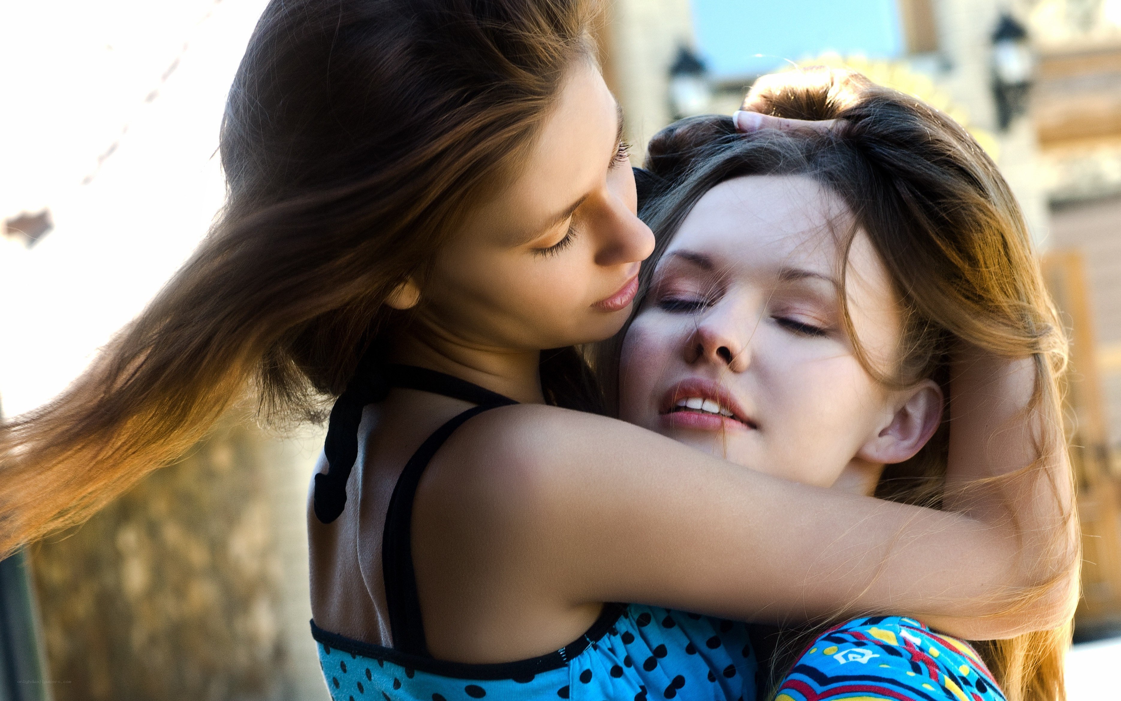 Two women embracing warmly