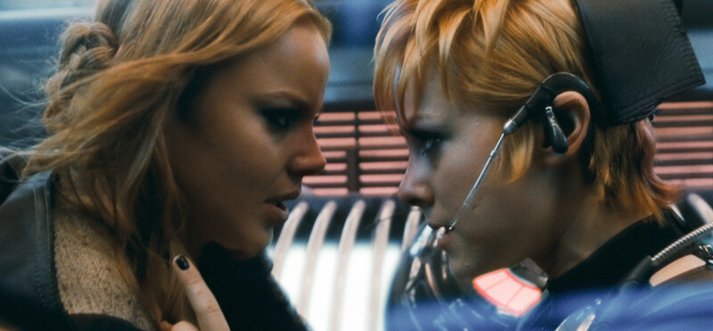 Two Women Facing Each Other — Blue