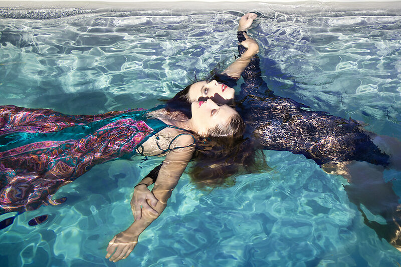 Two Women Floating in Pool
