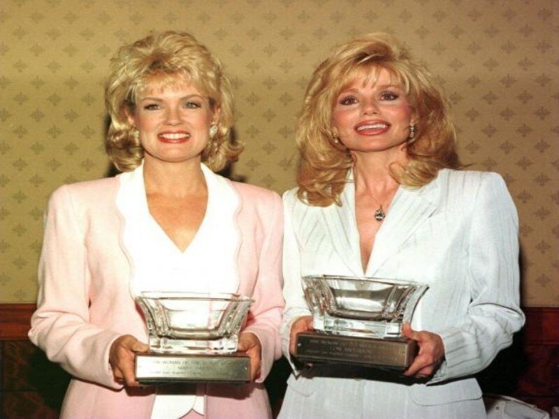 Two Women Holding Awards