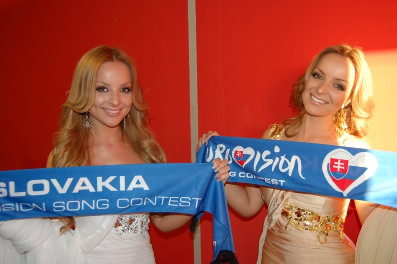 Two Women Holding Banner — Red