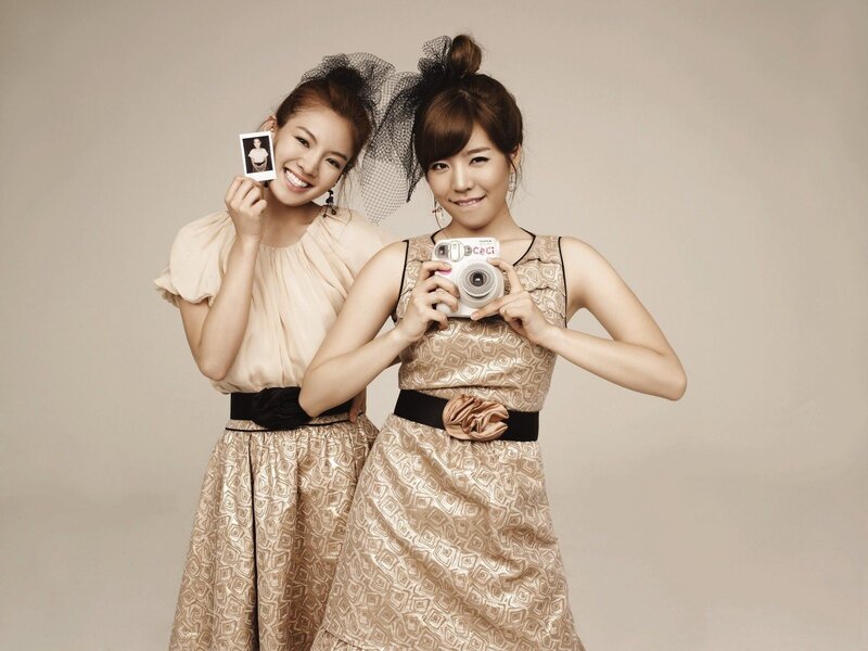 Two Women Holding Camera
