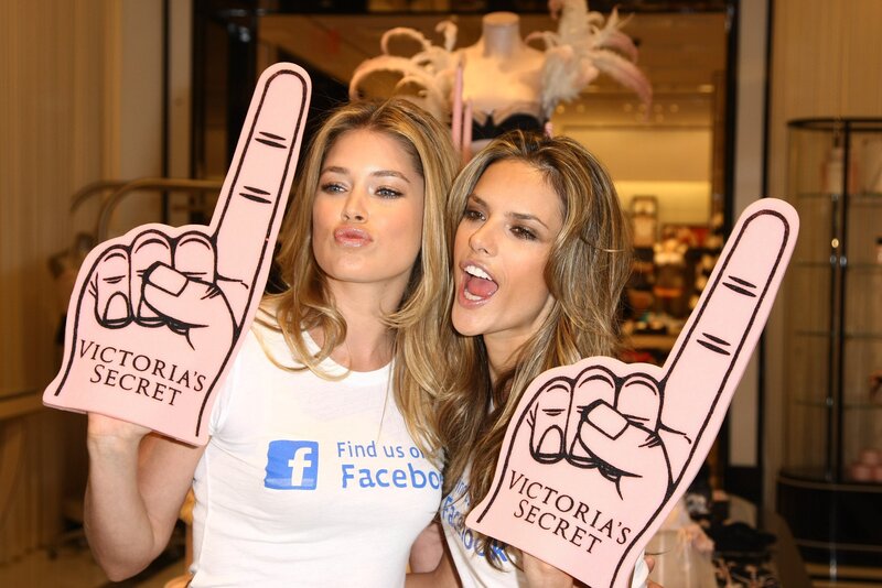 Two Women Holding Foam Fingers