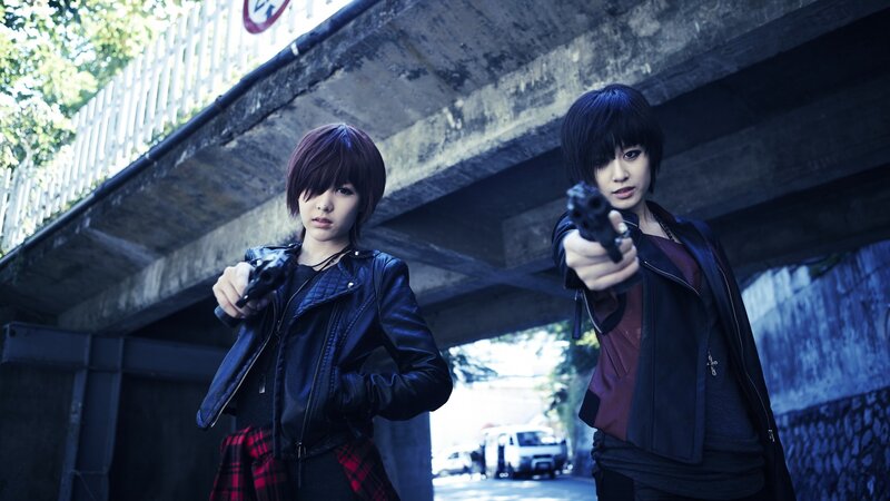 two women holding guns under bridge