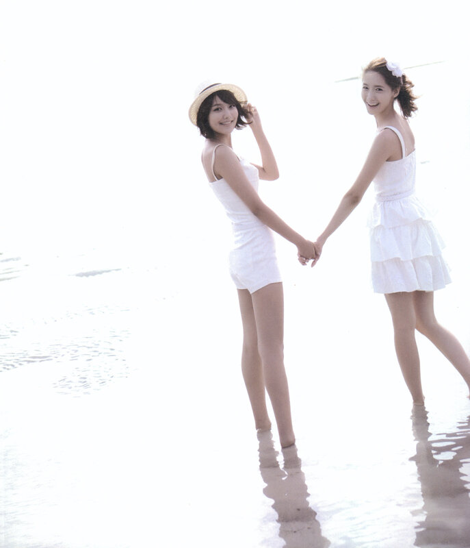 Two women holding hands on beach