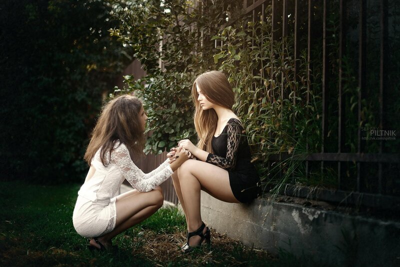 Two women holding hands outdoors
