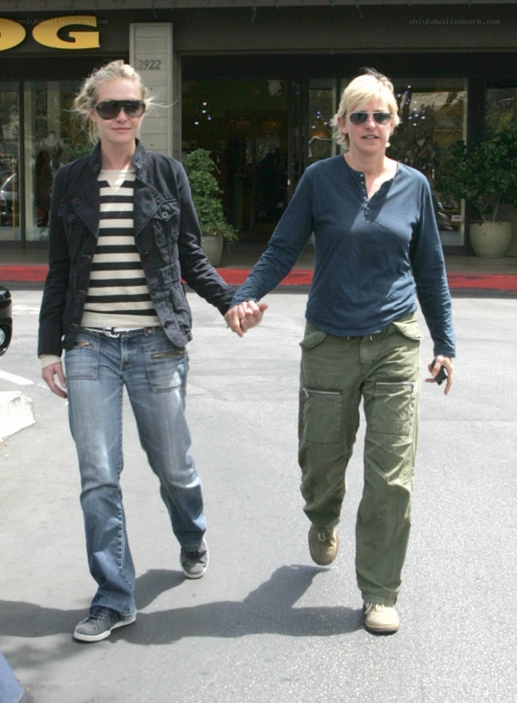 Two women holding hands walking