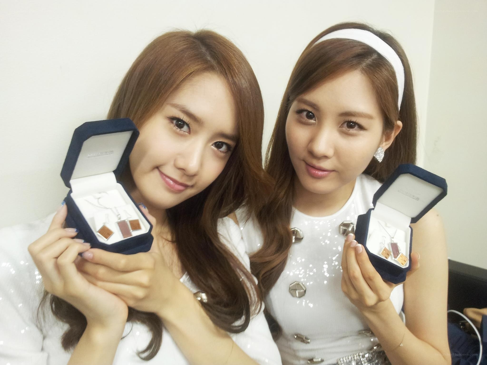two women holding jewelry boxes