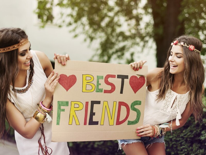 Two Women Holding Sign — White